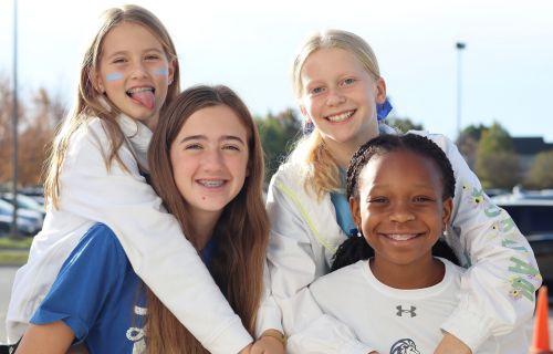 four girls giving piggy back rides